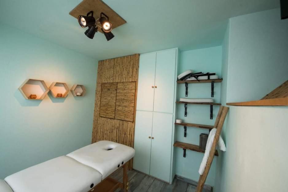 The calm treatment room at Ntouana with a massage table and bamboo panelling