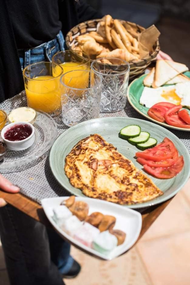 A tray carried to the garden with omelette, koulouria, jams and fresh orange juice