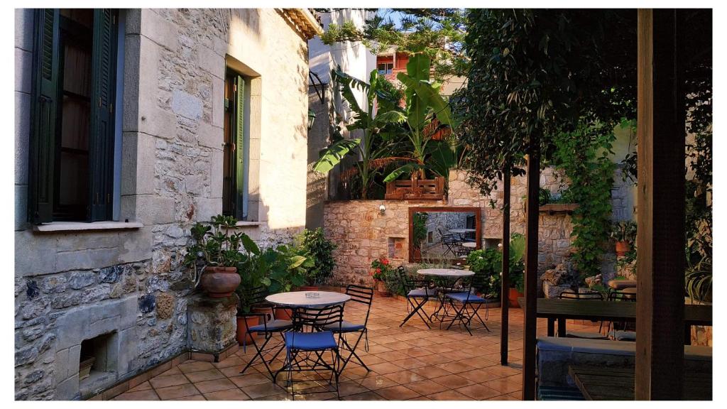 The inner stone courtyard with bistro tables, potted plants and terracotta tiles