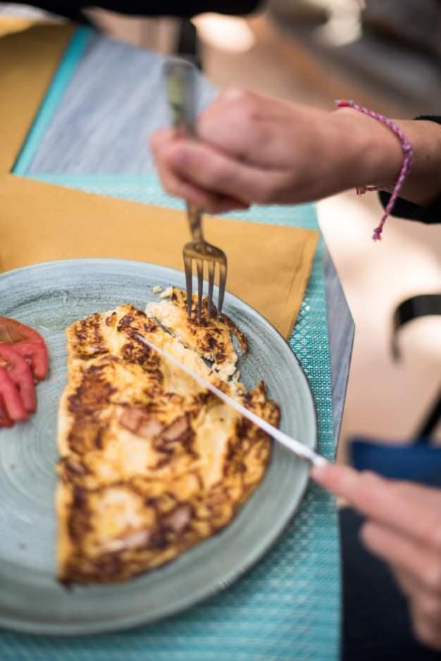 A freshly made omelette with tomato served on a stoneware plate