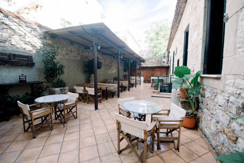 Bistro tables and director's chairs on the terracotta tiles of the courtyard